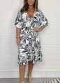 Detail of the high waist smocked design and tropical leaf print on this summer midi dress - Black