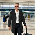 Classic black wool overcoat for men styled in a modern business travel airport setting - XS / Black