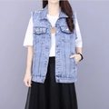 Detailed view of light blue denim vest with beaded pearls and frayed sleeve edges - XS / Blue Vest