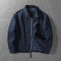 Detail of navy blue windbreaker jacket featuring zipper, buttons and brand inner label - M / Blue
