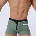 Detail of olive green men's swim trunks featuring a side zipper pocket and black drawstring - Army Green