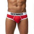 Gros plan sur un slip en coton rouge à taille basse avec ceinture élastique blanche - M / Rouge