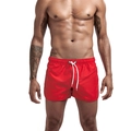 Detailed close-up of red quick-dry swim trunks for men featuring a white drawstring waistband - M / Red