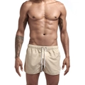 Detail of light beige quick-dry beach shorts featuring elastic drawstring waist and side slit - M / Khaki