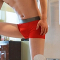 Detail of red seamless ice silk boxer briefs with wide elastic waistband on male model - M / Red