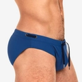 Close-up of men's dark blue swim briefs showing waist drawstring with metal tips - Navy Blue