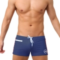 Close-up of men's navy swim trunks featuring a white zipper pocket and contrast red stripes - Dark Blue
