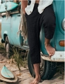 Detail of men's black drawstring waist casual shorts against a beach vacation background - S / Black