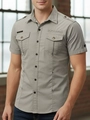 Detail view of cargo style short sleeve shirt with shoulder epaulettes and double pockets - Apricot