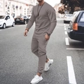 Street view of a man wearing a grey long sleeve casual tracksuit with drawstring joggers - S / Top And Bottom / Gray