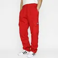 Detail of red cargo joggers showing elastic waistband and side pocket with small woven label - S / Bottoms / Red
