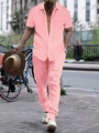 Close-up of men's summer coral pink short sleeve shirt and pants with vertical rib texture - Pink