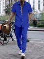 Detail of royal blue pleated fabric on men's short sleeve shirt and trouser set - Blue