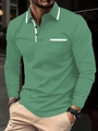 Detail van groen poloshirt met lange mouwen, witte contrastkraag en borstzakje - S / Groen