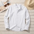Detail of white linen shirt showing mandarin collar, chest pocket and natural fabric texture - S / White