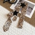Close-up detail of Y2K leopard print satin belt with black leather star accents - Leopard Print Style / Coffee Leopard Print