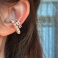 Close-up of elegant C-shaped ear cuff with pearls and zircons on ear. - Clip-On Earrings / Silver