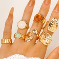 Detail shot of vintage gold-toned geometric rings with colorful resin stones on a hand. - Irregular Smooth Gemstone Set (7097)