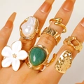 Close-up detail of vintage gold alloy ring set featuring white flower and green stone - Baroque Pearl Emerald Set (8010)