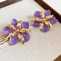 Detailed view of oversized purple oil-drip flower earrings with vintage gold finish - Stud Earrings / Purple