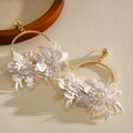 Detailed view of elegant gold hoop earrings with white leather floral design. - Standard Post Large Circle White Leather Flower Style / Gold with White