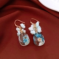 Detailed view of handmade vintage teardrop resin earrings with blue dried flowers - Flower Style (HE32042) / Lake Blue
