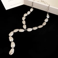 Macro detail showing the silver-toned hammered texture on the oval leaf tassel necklace - Rope Necklace / Silver