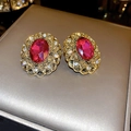 Close-up of vintage gold stud earrings with large oval pink crystal and filigree - Patterned Oval Style (21#)