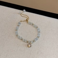 Detailed shot of cat-eye stone adjustable bracelet with a sparkling diamond charm - Drawstring Adjustable Style (HB517) / Gold