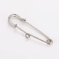 Detail view of a textured silver stainless steel safety pin waist cincher clip. - Steel