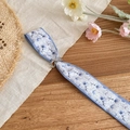 Detail view of a floral skinny silk scarf necklace with a silver adjustable metal buckle - Blue White Print