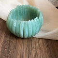 Macro view of a green marble textured acrylic geometric semi-circle elastic bracelet - Green