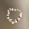 Primer plano detallado de una pulsera estilo dopamina con cuentas de concha blanca - Grande / Blanco con piedras multicolores