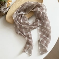 Close-up detail of retro brown plaid lightweight sheer scarf displayed on a white table - Coffee Fine Plaid