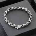 Detail view of a retro stainless steel corn chain bracelet with spindle shaped links. - Spindle Clasp Style (KB184832-KJX) / Silver