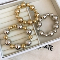 Macro view of metallic beaded bracelets in gold and silver finishes inside a jewelry box - Three-Piece Set / 34# Bangle Gold Silver