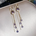Close-up of elegant floral dangle earrings with purple crystals and gold plating - Ear Line Style / Gold-Purple
