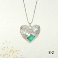 Close-up of heart pendant with emerald gemstone and zircon inlay on silver box chain - Silver Green Style (NE2259-B-2)