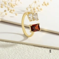 Detailed close-up of adjustable 18K gold ring with red and clear baguette zircon stones - Adjustable Open