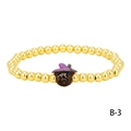 Close-up of Halloween beaded bracelet with golden beads and a pumpkin wizard charm - Dark Brown Witch Hat Pumpkin (BR1914-B-3)