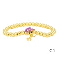 Close-up of gold beaded bracelet featuring a purple wizard hat cat pendant for Halloween - Yellow Wizard Cat (BR1914-C-1)