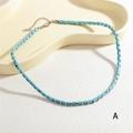 Close-up of turquoise cylindrical beads and silver spacers on a bohemian necklace - Cylindrical Tube Bead Necklace (NE2289-A) / Teal
