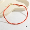 Detail view of red cylindrical beads with golden spacers on a choker necklace band - Red (NE2290-A)