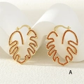 Golden monstera leaf earrings with orange cubic zirconia inlay and lever back closure - Gold Orange-Red Zirconia (ER0776-A)
