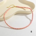 Close-up of pink stone beads and gold metal spacers on this elegant handmade choker - Pink (NE2290-B)