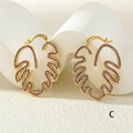 Macro shot of gold leaf-shaped earrings featuring purple zircon micro-inlays and hoop design - Gold Purple Zirconia (ER0776-C)