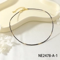 Natural beaded choker necklace with gold details, delicate and elegant jewelry piece for women. - Black and Gold Micro Beaded Choker (NE2478-A-1)