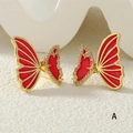 Detailed close-up of butterfly earrings with red enamel inlay and zircon accents - Red