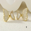 Detailed macro of butterfly earrings with white enamel wings and fine micro-pave crystals - White