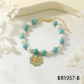 Detail of snake charm bracelet with turquoise beads, pearls and gold adjustable chain - Blue Howlite